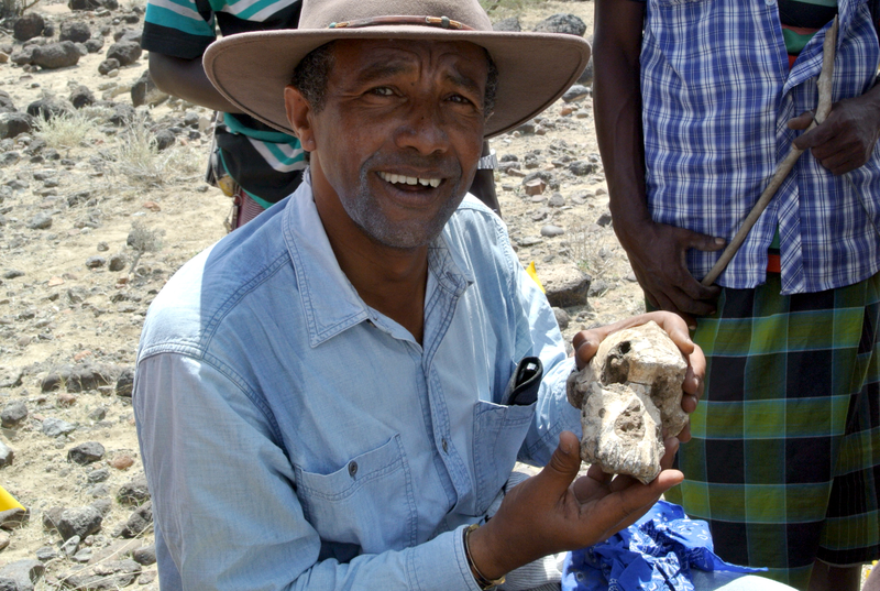Paleoanthropologist Yohannes Haile-Selassie holding the MRD fossil.